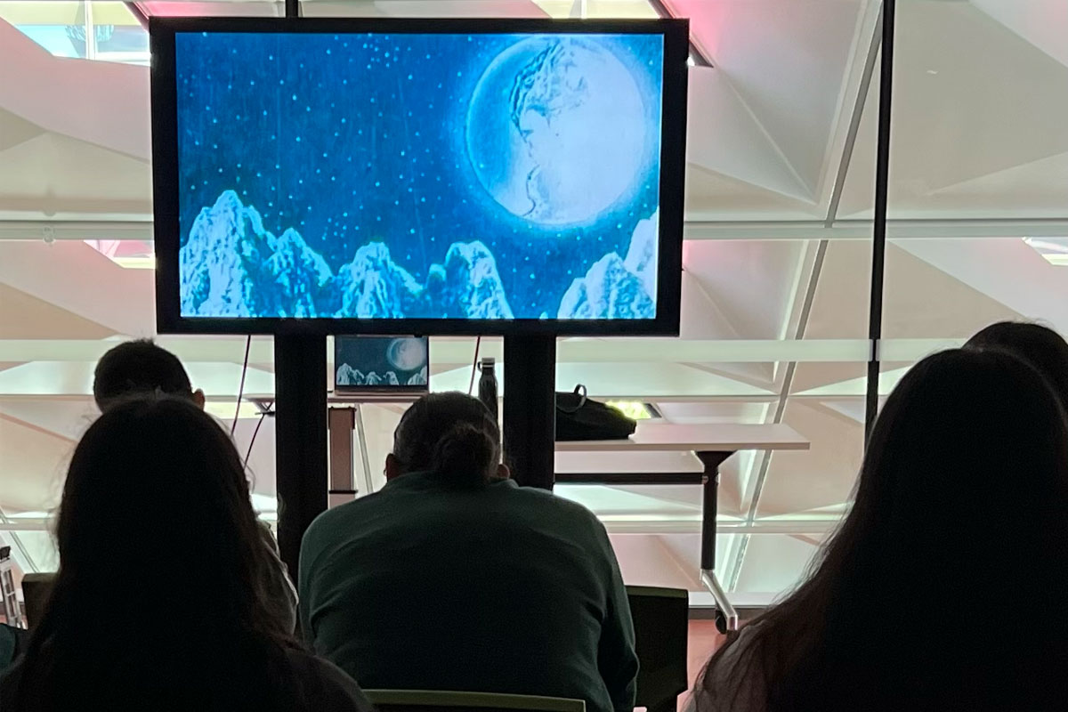 People watching a film about space